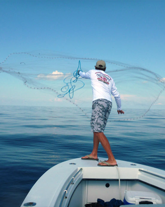 Captain Phil Throwing a Fishing Net | Fishing and Eco-Tour Charters in Fort Myers and Naples Florida - Pica Charters, LLC